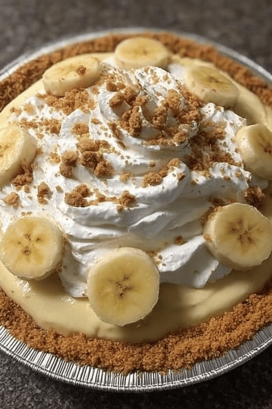 Easy Homemade Banana Cream Pie Recipe slice on plate showing perfect texture and swirl pattern